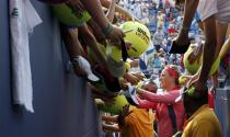 Victoria Azarenka of Belarus signs autographs for fans after defeating Alize Cornet of France in their match at the U.S. Open tennis championships in New York August 31, 2013. REUTERS/Kena Betancur