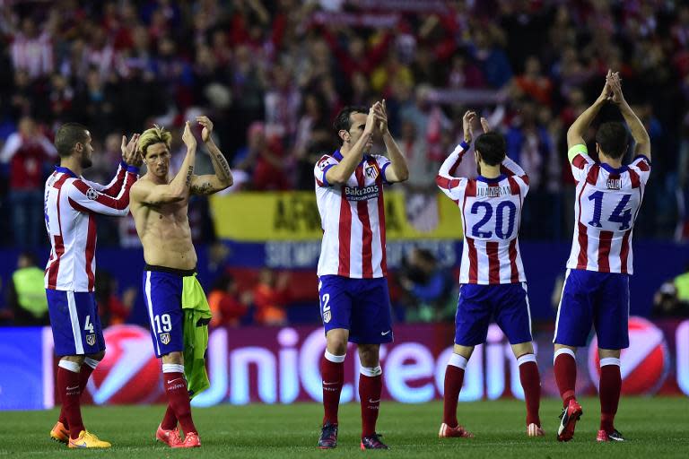 Atletico Madrid players thank supporters at the end of the Champions League quarter final first leg football match against Atletico Madrid in Madrid on April 14, 2015