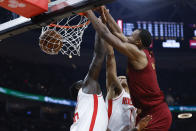 Cleveland Cavaliers forward Evan Mobley, right, dunks against Houston Rockets forward Usman Garuba, left, and forward Jabari Smith Jr. (1) during the first half of an NBA basketball game, Sunday, March 26, 2023, in Cleveland. (AP Photo/Ron Schwane)