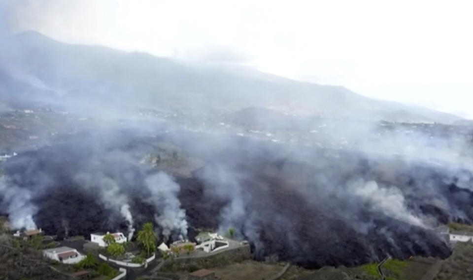 In this image made from video provided by OVERON, lava is seen after a volcanic eruption in La Palma, Spain, Monday, Sept. 20, 2021. Giant rivers of lava are tumbling slowly but relentlessly toward the sea after a volcano erupted on a Spanish island off northwest Africa. The lava is destroying everything in its path Monday, but prompt evacuations helped avoid casualties after Sunday's eruption. (OVERON via AP)
