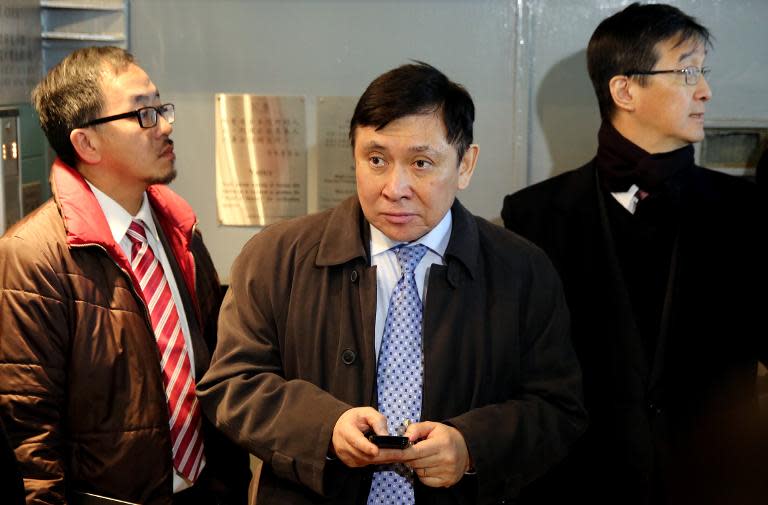 Raymond Kwok (C), brother of Thomas Kwok and co-chairman of development giant Sun Hung Kai Properties, leaves the High Court in Hong Kong, on December 22, 2014