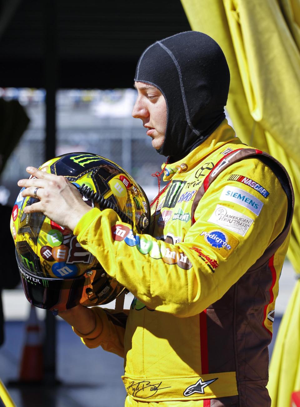 Kyle Busch removes his headgear after his qualifying run for the Daytona 500 NASCAR Sprint Cup Series auto race at Daytona International Speedway in Daytona Beach, Fla., Sunday, Feb. 16, 2014. (AP Photo/Terry Renna)