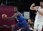 United States' Jrue Holiday (12), left, grabs the ball in front of Spain's Marc Gasol (13), right, during men's basketball quarterfinal game at the 2020 Summer Olympics, Tuesday, Aug. 3, 2021, in Saitama, Japan. (AP Photo/Charlie Neibergall)