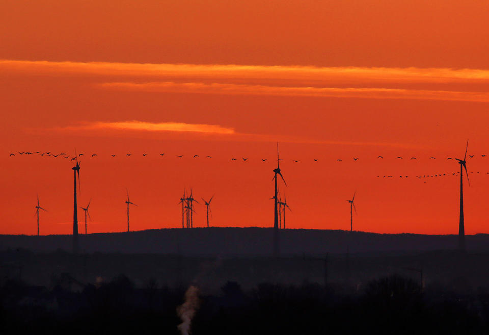 <p>A flock of birds flies past wind turbines just before sunrise in the outskirts of Frankfurt, Germany on March 28, 2017. A senior EU official says Wednesday, May 31, 2017, the EU and China will reaffirm their commitment to the Paris climate change accord this week, regardless of whether President Donald Trump pulls out of the pact. The official told reporters that the EU and China will also “spell out” how they plan to meet their commitments to the accord at talks in Brussels on Friday. (AP Photo/Michael Probst) </p>