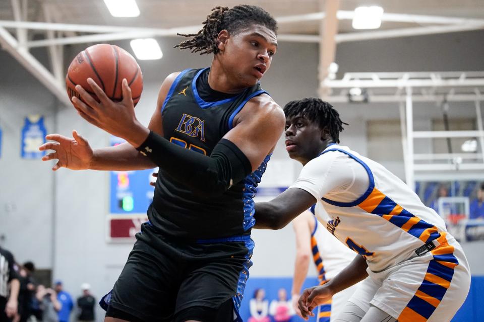 BGA’s Kavien Jones (23) moves the ball past Goodpasture's Joshua Huggins (24) during the fourth quarter at Goodpasture Christian School in Nashville, Tenn., Wednesday, Feb. 14, 2024.