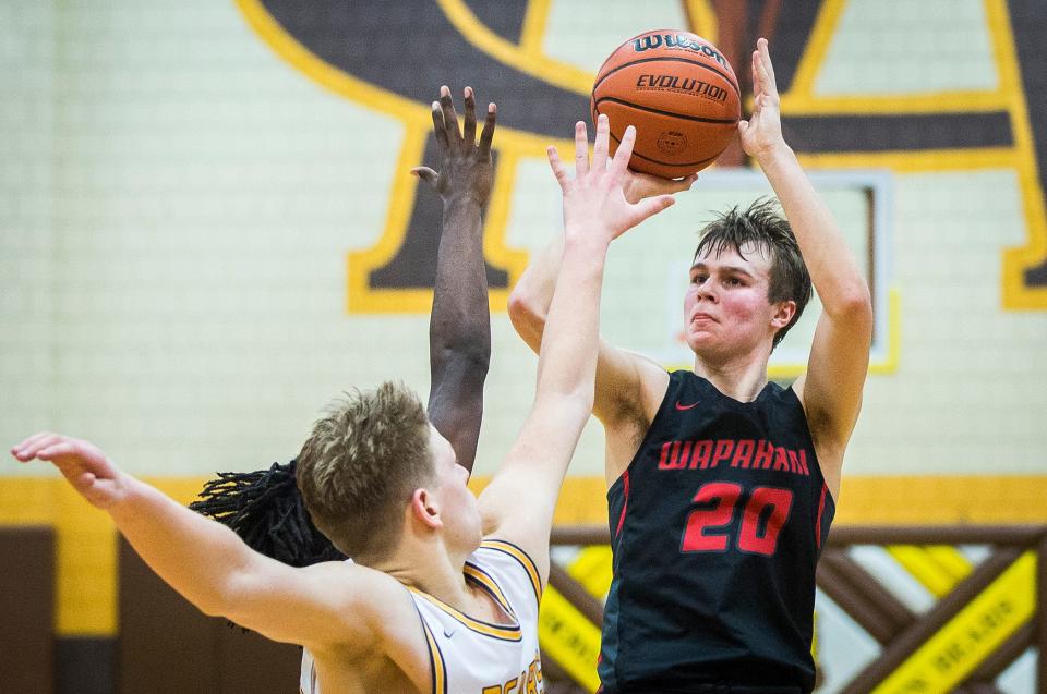 Wapahani's Isaac Andrews shoots over the defense during their game at Monroe Central High School Friday, Feb. 11, 2022.