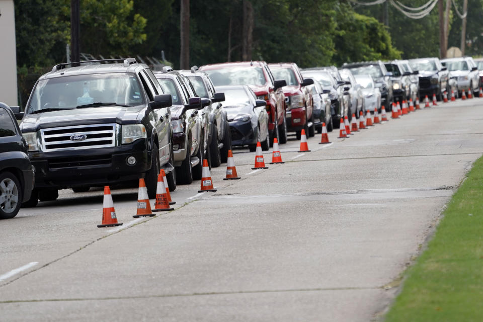 People wait inside their vehicles in line at COVID-19 testing site Wednesday, July 8, 2020, in Houston. Texas has surpassed 10,000 new coronavirus cases in a single day for the first time as a resurgence of the outbreak rages across the U.S. The record high of 10,028 confirmed cases Tuesday follows Republican Gov. Greg Abbott decision to mandate masks in much of the state and to close bars, retreating from what had been one of America’s fastest reopenings. (AP Photo/David J. Phillip)