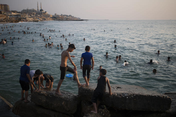 Palestinians beachgoers enjoy a summer day on the beach of Gaza City, Friday, Aug. 6, 2021. (AP Photo/Khalil Hamra)