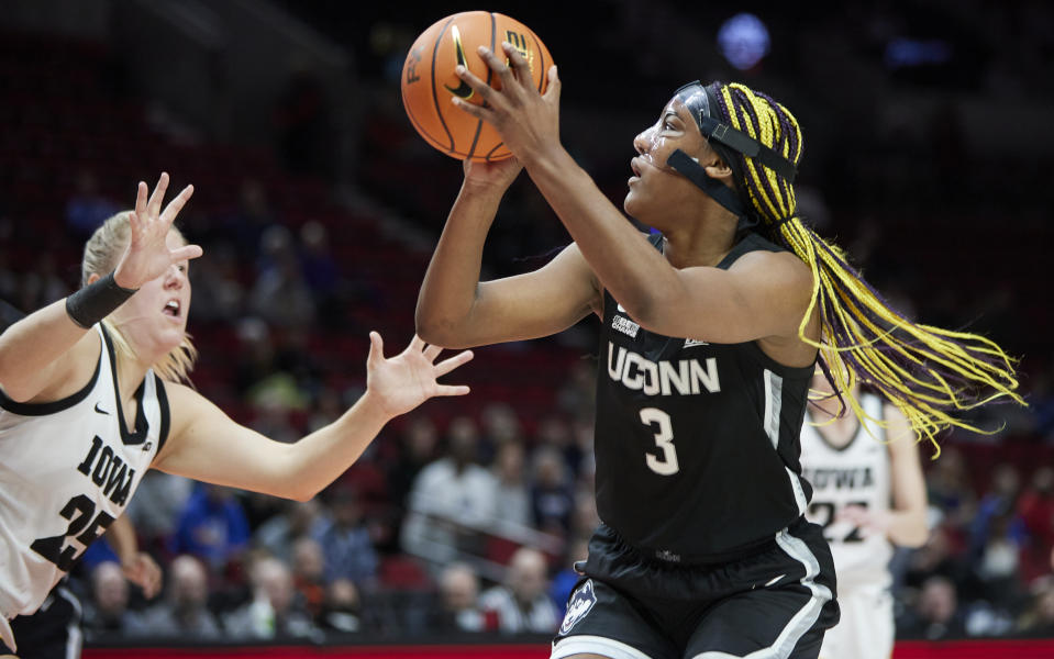 UConn forward Aaliyah Edwards, right, shoots over Iowa forward Monika Czinano during the first half of an NCAA college basketball game in the Phil Knight Legacy Championship in Portland, Ore., Sunday, Nov. 27, 2022. (AP Photo/Craig Mitchelldyer)