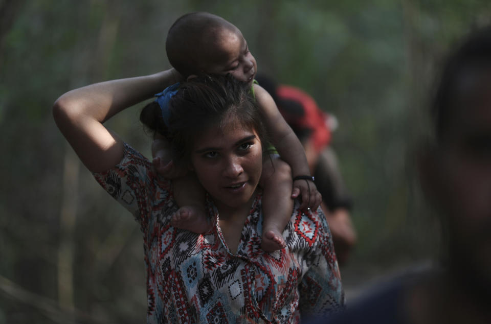 A woman carrying a baby crosses illegally into Colombia near the Simon Bolivar International Bridge, which remains closed by Venezuelan authorities, in La Parada, near Cucuta, Colombia, Sunday, March 3, 2019. Last weekend, opposition leader Juan Guaido coordinated a failed effort to bring aid from Colombia and Brazil into Venezuela, where security forces loyal to Venezuelan President Nicolas Maduro blocked the supplies at its border bridges, which remain closed, with Maduro describing Guaido’s gambit as part of a U.S.-backed plot to overthrow him. (AP Photo/Martin Mejia)