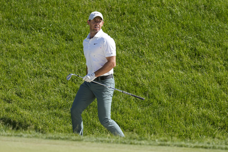 Rory McIlroy, of Northern Ireland, looks at his shot out of a bunker on the 17th green during the third round of the Memorial golf tournament Saturday, June 4, 2022, in Dublin, Ohio. (AP Photo/Darron Cummings)