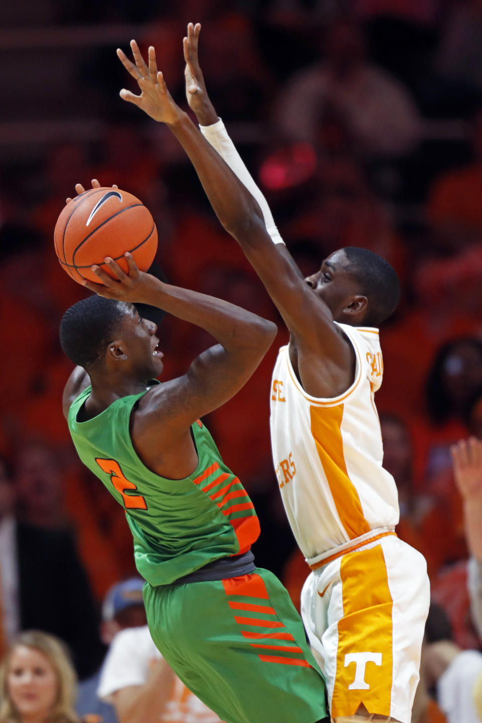 Florida A&M guard Kamron Reaves (2) tries to shoot over Tennessee guard Davonte Gaines (0) during the first half of an NCAA college basketball game Wednesday, Dec. 4, 2019, in Knoxville, Tenn. (AP Photo/Wade Payne)