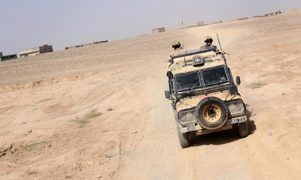 Soldiers patrol in a Snatch Land Rover in Helmand, Afghanistan, in 2006