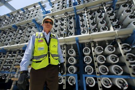Poseidon Water project manager Peter MacLaggen stands next to some of the reverse osmosis filters as work continues on the Western Hemisphere's largest seawater desalination plant in Carlsbad, California, April 14, 2015. REUTERS/Mike Blake