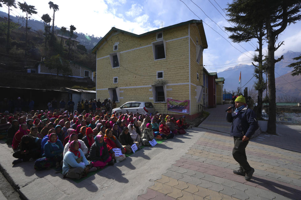 A local leader addresses a group of protesting women demanding to save their town, in Joshimath, in India's Himalayan mountain state of Uttarakhand, Jan. 19, 2023. For months, residents in Joshimath, a holy town burrowed high up in India's Himalayan mountains, have seen their homes slowly sink. They pleaded for help, but it never arrived. In January however, their town made national headlines. Big, deep cracks had emerged in over 860 homes, making them unlivable. (AP Photo/Rajesh Kumar Singh)