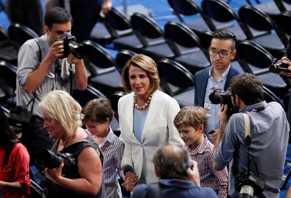 U.S. House Minority Leader Nancy Pelosi (D-CA) walks with two of her grandsons.