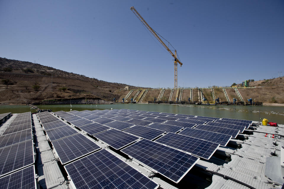 An island of solar panels floats in a pond at the Los Bronces mining plant, about 65 kilometers (approximately 40 miles) from Santiago, Chile, Thursday, March 14, 2019. The island of solar panels could give purpose to mine refuse in Chile by using them to generate clean energy and reduce water evaporation.(AP Photo / Esteban Felix)