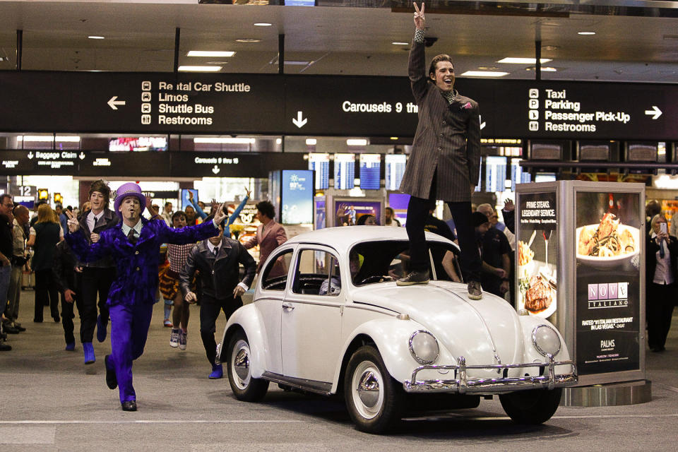 FILE - Performers with Cirque du Soleil's "The Beatles LOVE" make their grand entrance for a performance at McCarran International Airport in Las Vegas, Aug. 21, 2014. On Tuesday, April 9, 2024, it was announced that the final curtain will come down July 7 on Cirque du Soleil's long-running show “The Beatles Love," a cultural icon on the Las Vegas Strip that brought band members Paul McCartney and Ringo Starr back together for public appearances throughout its 18-year run. (Eric Verduzco/Las Vegas Review-Journal via AP, File)