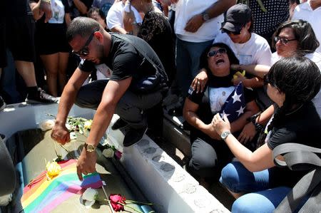 Lucyvette Padro (R) accompanied by family and friends attends the funeral of her son Angel Candelario, one of the victims of the shooting at the Pulse night club in Orlando, at his hometown of Guanica, Puerto Rico, June 18, 2016. REUTERS/Alvin Baez
