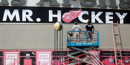 Workers hang a "Thank you Mr Hockey" banner above the Gordie Howe entrance of the Joe Louis Hockey Arena in memory of late National Hockey League (NHL) player Gordie Howe in Detroit, Michigan, U.S. June 10, 2016. REUTERS/Rebecca Cook