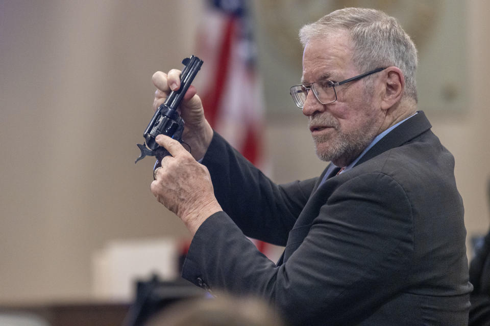 Lucien Haag shows the jury a gun exactly like the evidence gun during the involuntary manslaughter trial of Hannah Gutierrez-Reed.