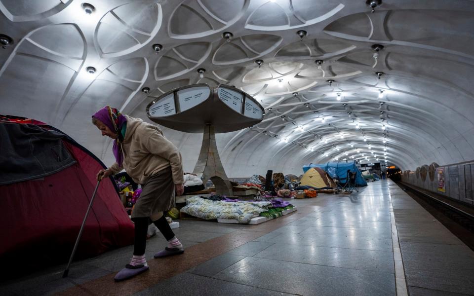 An elderly woman walks through a metro station that is being used as a bomb shelter in Kharkiv - Mstyslav Chernov 