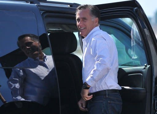 US Republican presidential candidate Mitt Romney pauses before entering his SUV after arrival in Las Vegas, Nevada