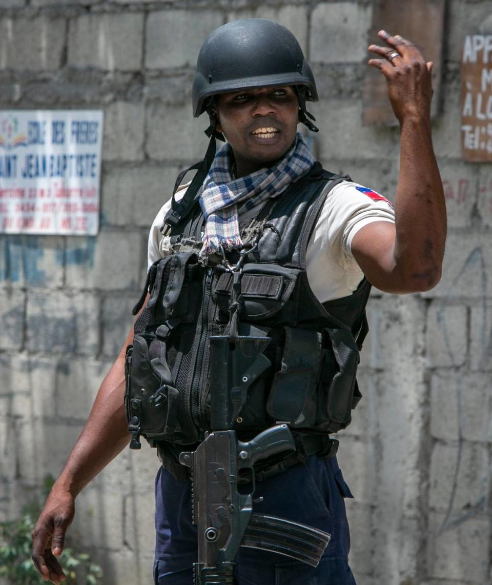 Port-au-Prince, June 23, 2022 - A Haitian National Police officer direct traffic at a Police checkpoint in Port-au-Prince.