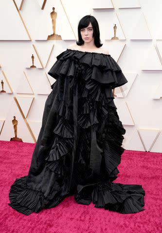 <p>Kevin Mazur / WireImage / Getty Images</p> Billie Eilish wears a black dress at the 2022 Oscars.