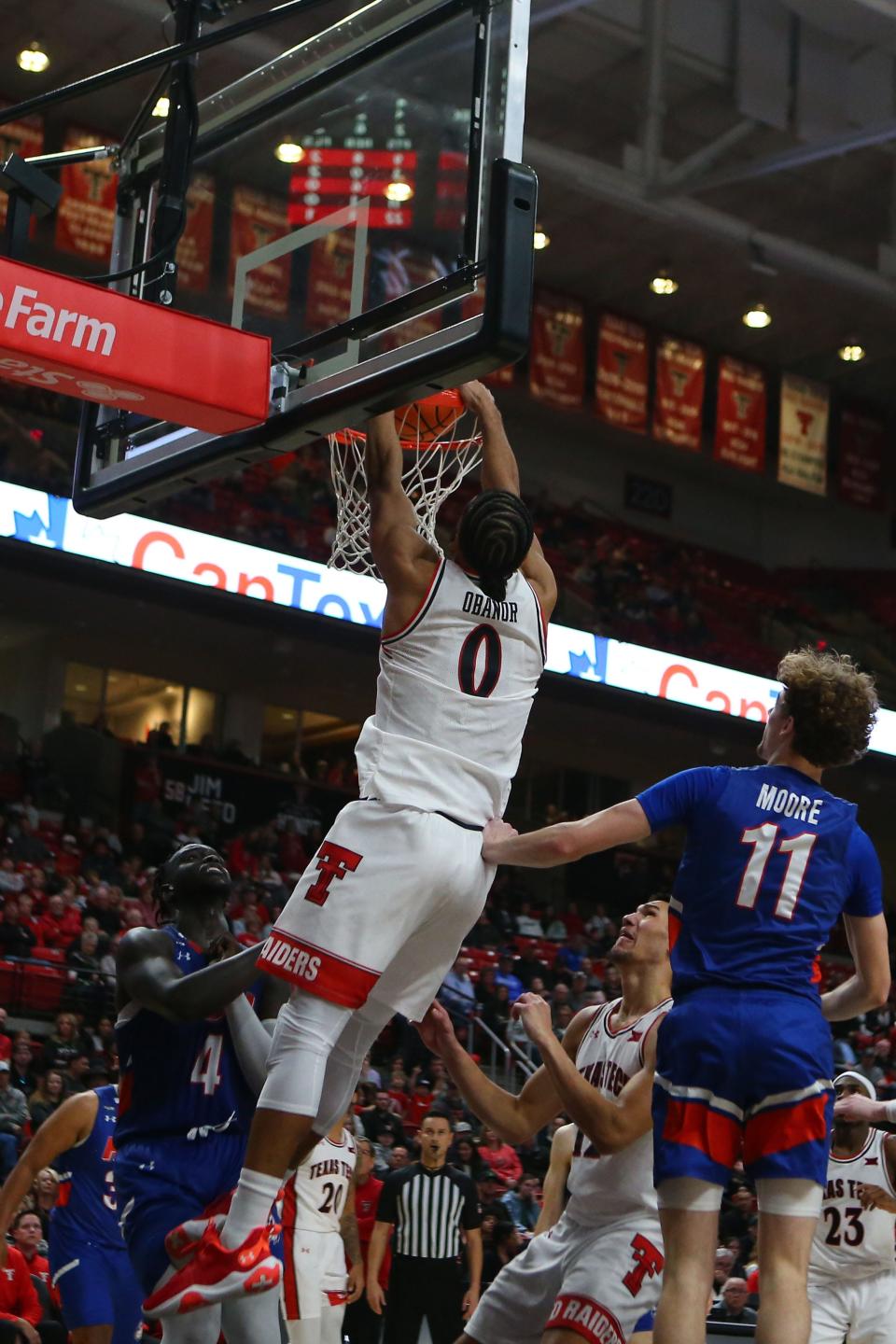 Texas Tech forward Kevin Obanor (0) dunks the ball against Houston Christian center Bonke Maring (4) and forward Tristan Moore (11) in the second half of a nonconference game Wednesday at United Supermarkets Arena. Obanor finished with 22 points and nine rebounds. [Michael C. Johnson-USA TODAY Sports]