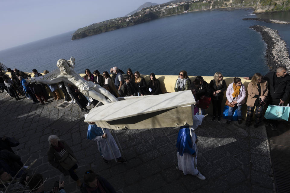 People carry a "Mistero", a float depicting a biblical scene during a procession in Procida Island, Italy, Friday, March 29, 2024. Italy is known for the religious processions that take over towns big and small when Catholic feast days are celebrated throughout the year. But even in a country where public displays of popular piety are a centuries-old tradition, Procida's Holy Week commemorations stand out. (AP Photo/Alessandra Tarantino)