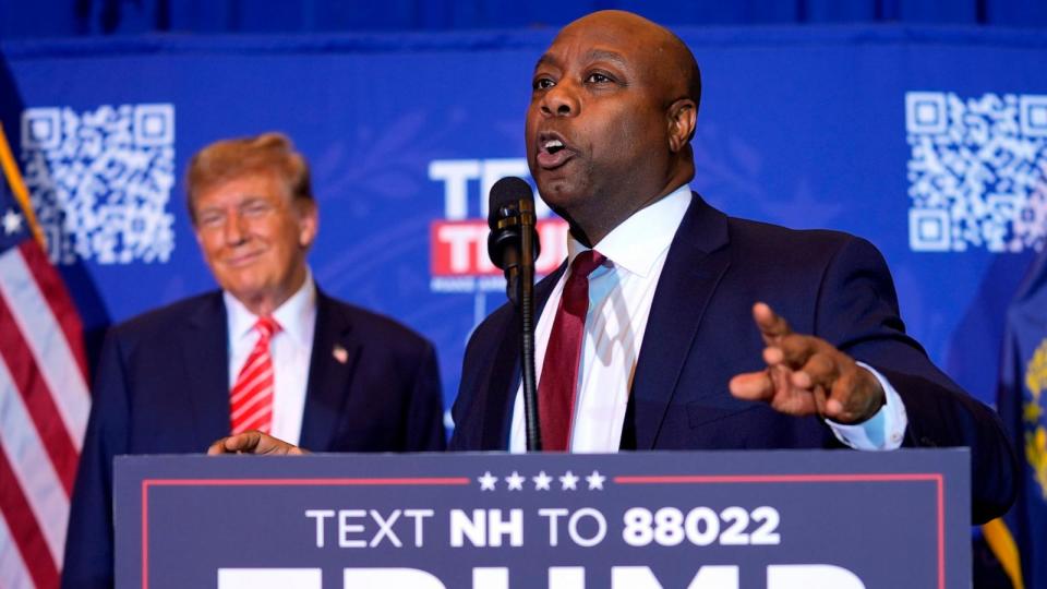 PHOTO: Republican presidential candidate former President Donald Trump listens as Sen. Tim Scott speaks at a campaign event in Concord, N.H., on Jan. 19, 2024.  (Matt Rourke/AP)