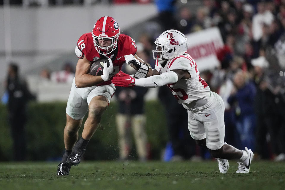 Georgia tight end Brock Bowers (19) runs after a catch as Mississippi safety Nick Cull (29) defends during the first half of an NCAA college football game, Saturday, Nov. 11, 2023, in Athens, Ga. (AP Photo/John Bazemore)