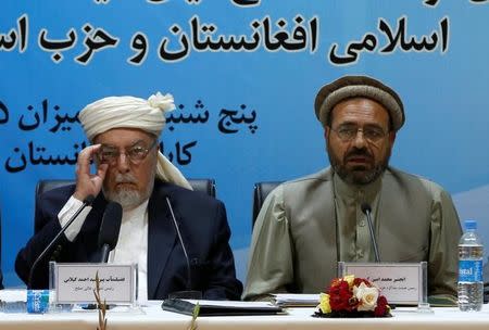 Mohammad Amin Karim (R), representative of Gulbuddin Hekmatyar, and Sayed Ahmad Gilani, head of the government's High Peace Council, speak after signing a peace deal in Kabul, Afghanistan, September 22, 2016. REUTERS/Omar Sobhani