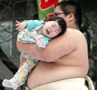 TOKYO, JAPAN - APRIL 29: Sumo wrestler students try to make babies cry during the Crying Sumo competition at Sensoji Temple on April 29, 2006 in Tokyo, Japan. The first baby that cries wins this competition. The ceremony has been taking place in Japan to wish for the good health of the child as it is said that crying is good for the health of babies. Majority of the children who participate are less than 1 year old. (Photo by Junko Kimura/Getty Images)