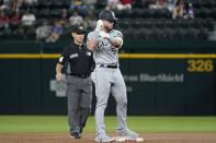 Chicago White Sox's Romy Gonzalez (5) gestures to the dugout as he celebrates his RBI double during the second inning of the team's baseball game against the Texas Rangers, as umpire Mark Wegner stands nearby in Arlington, Texas, Friday, Sept. 17, 2021. (AP Photo/Tony Gutierrez)