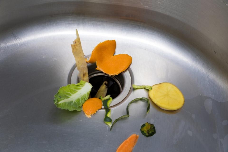 Food scraps around kitchen sink drain
