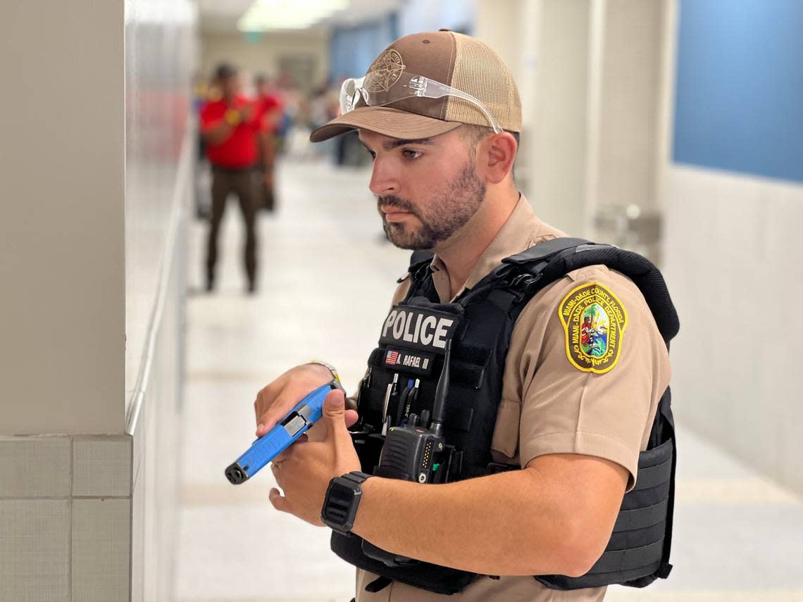 A Miami-Dade police officer wields a training gun during an active-shooter training at Palmetto High on Aug. 1, 2022.