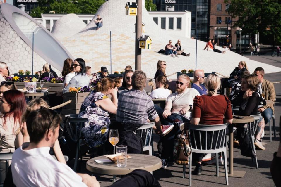 People sitting on a terrace outside enjoy drinks in Helsinki, Finland on June 1, 2020, after months of lockdown measures.