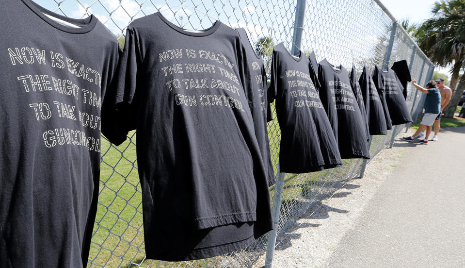 <p>T-shirts hang on a fence near Marjory Stoneman Douglas High School in Parkland, Fla., Feb. 23, 2018. (Photo: Joe Skipper/Reuters) </p>