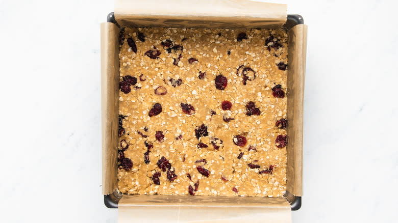 Cranberry oat bar mixture in baking pan