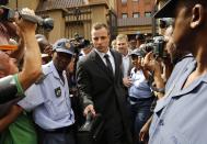 Olympic and Paralympic track star Oscar Pistorius leaves court after the fifth day of his trial for the murder of his girlfriend Reeva Steenkamp at the North Gauteng High Court in Pretoria, March 7, 2014. REUTERS/Mike Hutchings(SOUTH AFRICA - Tags: SPORT ATHLETICS CRIME LAW)