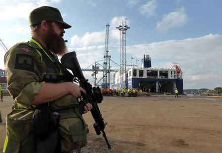 A Norwegian soldier stands guard as German military equipment is unloaded at Fredrikstad, Norway, September 7, 2018. REUTERS/Gwladys Fouche