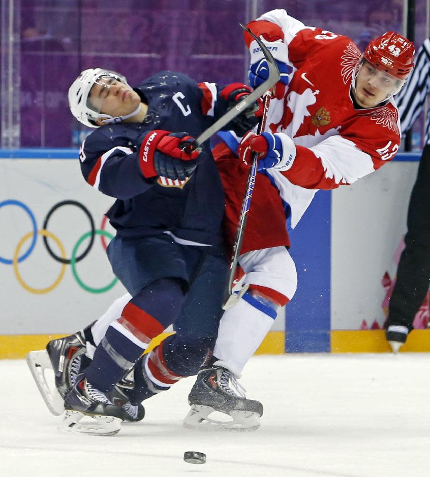 USA forward Zach Parise collides with Russia forward Valeri Nichushkin in t...