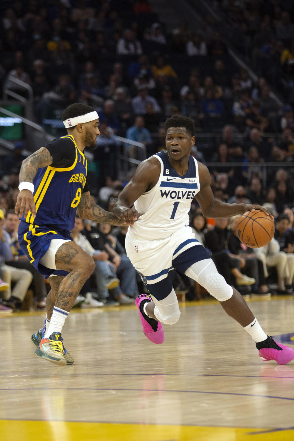 Golden State Warriors guard Gary Payton II (8) defends against Minnesota Timberwolves guard Anthony Edwards (1) during the second quarter of an NBA basketball game, Sunday, March 26, 2023, in San Francisco. (AP Photo/D. Ross Cameron)