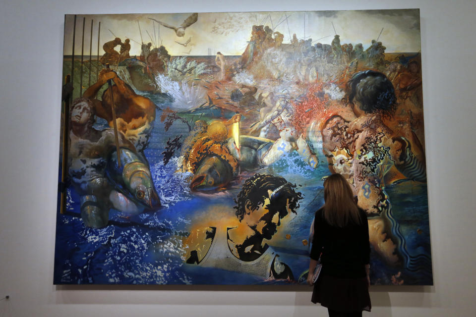 A visitor looks at a painting entitled 'Peche au thon' (Tuna Fishing ) by Spanish surrealist artist Salvador Dali during an exhibition devoted to his work at the Centre Pompidou contemporary art center (aka Beaubourg) on November 19, 2012 in Paris. More than 30 years after the first retrospective in 1979, the event gathers more than 200 art pieces and runs until March 13, 2013. (FRANCOIS GUILLOT/AFP/Getty Images)
