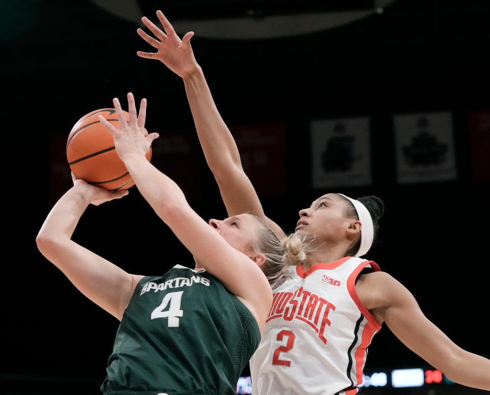 Michigan State guard Theryn Hallock is guarded by Ohio State's Taylor Thierry during the second quarter of the Buckeyes' 70-65 win Sunday.