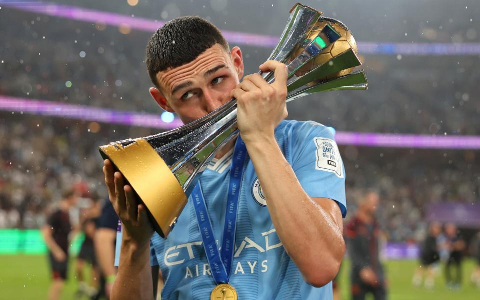 Phil Foden kisses the Club World Cup trophy