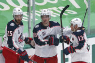 Columbus Blue Jackets center Mikhail Grigorenko (25), center Jack Roslovic (96) and right wing Cam Atkinson (13) celebrate a first-period goal against the Dallas Stars during an NHL hockey game Thursday, April 15, 2021, in Dallas. (AP Photo/Richard W. Rodriguez)