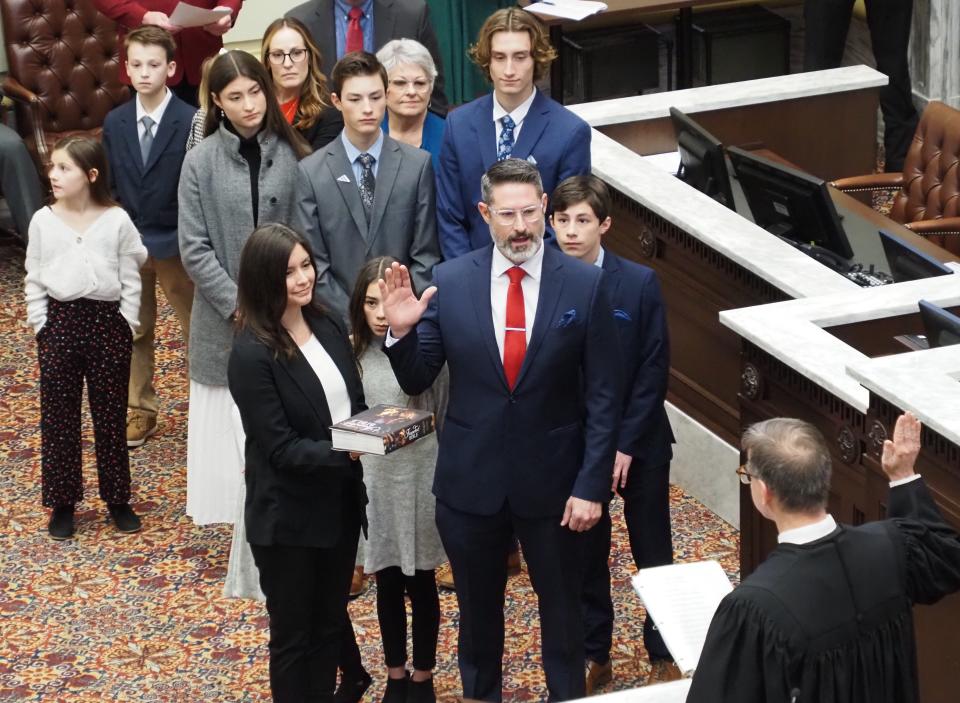 Surrounded by members of his family, newly elected Sen. Dusty Deevers, R-Elgin, takes his oath of office.